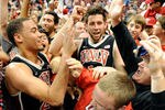 LAS VEGAS, NV - NOVEMBER 26:  Chace Stanback (L) #22 and Carlos Lopez #11 of the UNLV Rebels celebrate with fans after the team's 90-80 win over the North Carolina Tar Heels in the championship game of the Continental Tire Las Vegas Invitational at the Orleans Arena November 26, 2011 in Las Vegas, Nevada.  (Photo by Ethan Miller/Getty Images)
