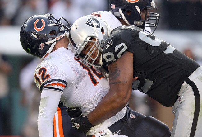 OAKLAND, CA - NOVEMBER 27:  Richard Seymour #92 of the Oakland Raiders hits Caleb Hanie #12 of the Chicago Bears after Hanie threw the ball at O.co Coliseum on November 27, 2011 in Oakland, California.  (Photo by Ezra Shaw/Getty Images)