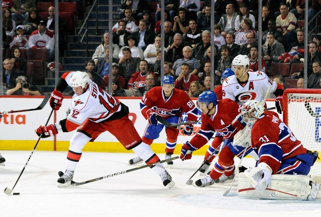 MONTREAL, CANADA - NOVEMBER 16:  Eric Staal #12 of the Carolina Hurricanes stick handles the puck in front of Josh Gorges #26 and Carey Price #31 of the Montreal Canadiens during the NHL game at the Bell Centre on November 16, 2011 in Montreal, Quebec, Canada.  The Canadiens defeated the Hurricanes 4-0.  (Photo by Richard Wolowicz/Getty Images)
