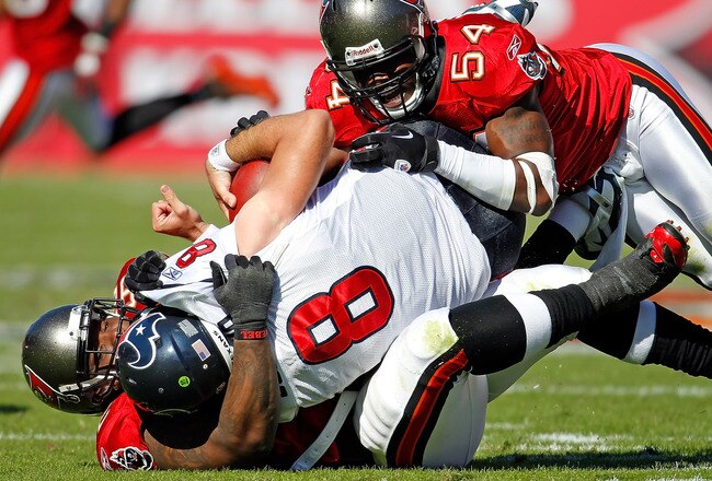 TAMPA, FL - NOVEMBER 13:  Defensive tackle Brain Price #92 of the Tampa Bay Buccaneers sacks quarterback Matt Schaub #8 of the Houston Texans as linebacker Geno Hayes #54 cleans up during the game at Raymond James Stadium on November 13, 2011 in Tampa, Florida.  (Photo by J. Meric/Getty Images)