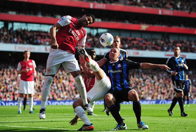 LONDON, ENGLAND - OCTOBER 23:  (L-R) Andre Santos of Arsenal, Marouane Chamakh of Arsenal and Jonathan Walters of Stoke City challenge for the ball during the Barclays Premier League match between Arsenal and Stoke City at the Emirates Stadium on October 23, 2011 in London, England.  (Photo by Jamie McDonald/Getty Images)