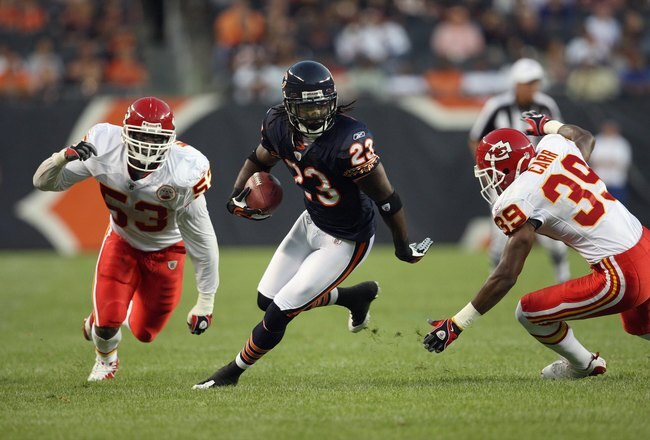 CHICAGO - AUGUST 7:  Devin Hester #23 of the Chicago Bears carries the ball against Demorrio Williams #53 and Brandon Carr #39 of the Kansas City Chiefs during a preseason game on August 7, 2008 at Soldier Field in Chicago, Illinois. (Photo by Jonathan Daniel/Getty Images)