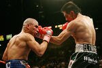 LAS VEGAS - JULY 26:  Antonio Margarito (R) hits Miguel Cotto during their WBA welterweight title fight at the MGM Grand Garden Arena July 26, 2008 in Las Vegas, Nevada. Margarito won by TKO in the 11th round.  (Photo by Ethan Miller/Getty Images)