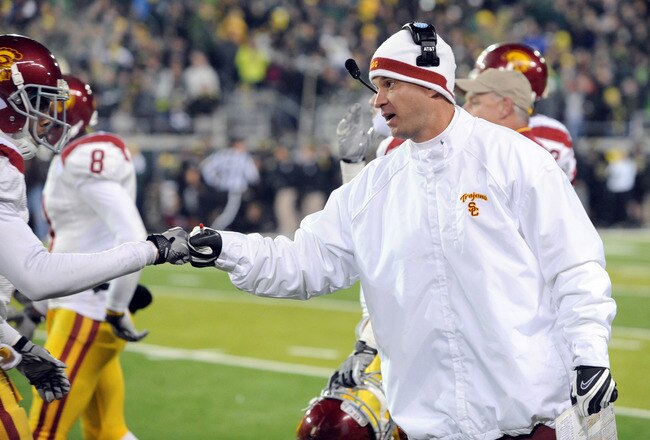 EUGENE, OR - NOVEMBER 19:  Head coach Lane Kiffin of the USC Trojans greets safety T.J. McDonald #7 of the USC Trojans as he comes off the field in the fourth quarter of the game against the Oregon Ducks at Autzen Stadium on November 19, 2011 in Eugene, Oregon. USC won the game 38-35. (Photo by Steve Dykes/Getty Images)