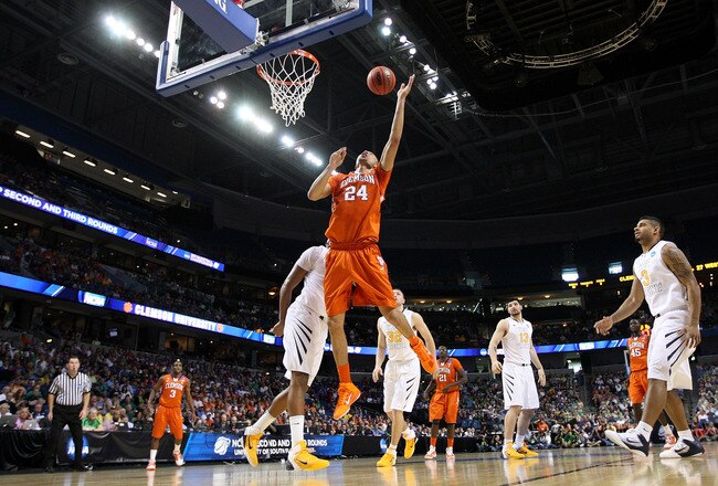 TAMPA, FL - MARCH 17:  Milton Jennings #24 of the Clemson Tigers reaches for the ball in the first half against the West Virginia Mountaineers during the second round of the 2011 NCAA men's basketball tournament at St. Pete Times Forum on March 17, 2011 in Tampa, Florida.  (Photo by Mike Ehrmann/Getty Images)