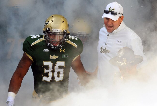 TAMPA, FL - NOVEMBER 25:  Linebacker Sam Barrington #36 and coach Skip Holtz of the South Florida Bulls take the field for play against the Louisville Cardinals November 25, 2011 at Raymond James Stadium in Tampa, Florida.  Louisville won 34 - 24.  (Photo by Al Messerschmidt/Getty Images)