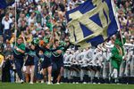 SOUTH BEND, IN - OCTOBER 03: Cheerleaders and the leprechaun mascot of the Notre Dame Fighting Irish run onto the field before a game against the Washington Huskies on October 3, 2009 at Notre Dame Stadium in South Bend, Indiana. Notre Dame defeated Washington 37-30in overtime. (Photo by Jonathan Daniel/Getty Images)