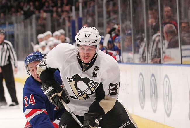 NEW YORK, NY - NOVEMBER 29:  Sidney Crosby #87 of the Pittsburgh Penguins skates with the puck under pressure from Ryan Callahan #24 of the New York Rangers at Madison Square Garden on November 29, 2011 in New York City.  (Photo by Nick Laham/Getty Images)