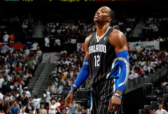 ATLANTA, GA - APRIL 28:  Dwight Howard #12 of the Orlando Magic walks to the bench after a turnover to the Atlanta Hawks during Game Six of the Eastern Conference Quarterfinals in the 2011 NBA Playoffs at Philips Arena on April 28, 2011 in Atlanta, Georgia.  NOTE TO USER: User expressly acknowledges and agrees that, by downloading and or using this photograph, User is consenting to the terms and conditions of the Getty Images License Agreement.  (Photo by Kevin C. Cox/Getty Images)