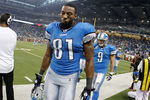 DETROIT, MI - NOVEMBER 24:  Calvin Johnson #81 and  Matthew Stafford #9 of the Detroit Lions leave the field after scoring a fourth quarter touchdown but still losing the game 1-28 to the Green Bay Packers at Ford Field on November 24, 2011 in Detroit, Michigan.  Green Bay won the game 27-15. (Photo by Gregory Shamus/Getty Images)