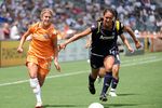 CARSON, CA - AUGUST 22:  Kacey White #20 of the New Jersey Blue Sky is chased by Collette McCallum #14 of the Los Angeles Sol during the WPS Championship at The Home Depot Center on August 22, 2009 in Carson, California.  The Blue Sky won 1-0 to win the WPS Championship.  (Photo by Harry How/Getty Images)