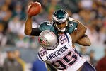 PHILADELPHIA, PA - NOVEMBER 27:  Vince Young #9 of the Philadelphia Eagles is tackled by Mark Anderson #95 of the New England Patriots at Lincoln Financial Field on November 27, 2011 in Philadelphia, Pennsylvania.  (Photo by Rich Schultz/Getty Images)