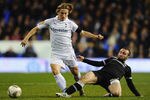 LONDON, ENGLAND - NOVEMBER 30:  Dimitris Salpingidis of PAOK FC tackles Luka Modric of Spurs during the UEFA Europa League Group A between Tottenham Hotspur and PAOK Salonika match at White Hart Lane on November 30, 2011 in London, England.  (Photo by Mike Hewitt/Getty Images)