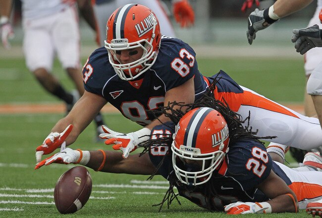 CHAMPAIGN, IL - NOVEMBER 19:  Eddie Viliunas #83 and Troy Pollard #28 of the Illinois Fighting Illini dive for the ball after a missed catch on a kick-off against the Wisconsin Badgers at Memorial Stadium on November 19, 2011 in Champaign, Illinois. Wisconsin defeated Illinois 28-17.  (Photo by Jonathan Daniel/Getty Images)