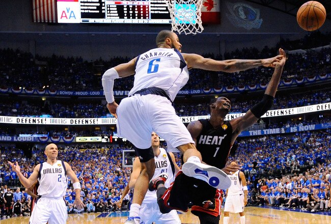 DALLAS, TX - JUNE 09:  Chris Bosh #1 of the Miami Heat drives for a shot attempt against Tyson Chandler #6 of the Dallas Mavericks in Game Five of the 2011 NBA Finals at American Airlines Center on June 9, 2011 in Dallas, Texas.  NOTE TO USER: User expressly acknowledges and agrees that, by downloading and/or using this Photograph, user is consenting to the terms and conditions of the Getty Images License Agreement.  (Photo by Larry W. Smith-Pool/Getty Images)