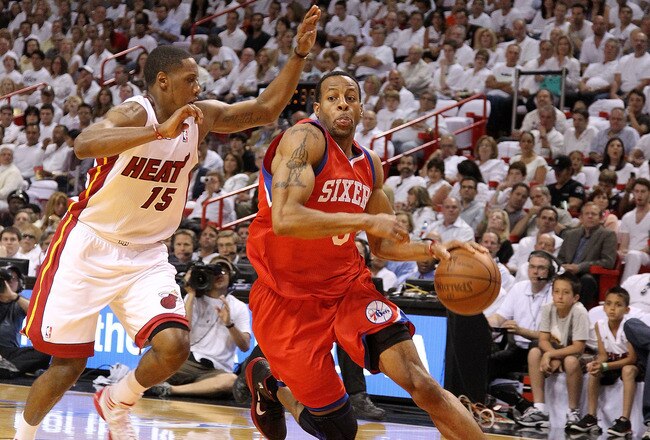 MIAMI, FL - APRIL 27: Andre Iguodala #9 of the Philadelphia 76ers drives to the rim past Mario Chalmers #15 of the Miami Heat during game five of the Eastern Conference Quarterfinals in the 2011 NBA Playoffs at American Airlines Arena on April 27, 2011 in Miami, Florida. NOTE TO USER: User expressly acknowledges and agrees that, by downloading and/or using this Photograph, User is consenting to the terms and conditions of the Getty Images License Agreement. (Photo by Mike Ehrmann/Getty Images)