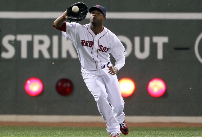 BOSTON, MA - AUGUST 30:  Carl Crawford #13 of the Boston Red Sox makes the catch for the out against the New York Yankees on August 30, 2011 at Fenway Park in Boston, Massachusetts.  (Photo by Elsa/Getty Images)