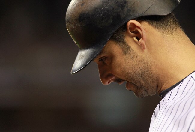 NEW YORK, NY - OCTOBER 06:  Jorge Posada #20 of the New York Yankees walks back to the dugout with his head down after he grounded out in the bottom of the eighth inning against the Detroit Tigers during Game Five of the American League Championship Series at Yankee Stadium on October 6, 2011 in the Bronx borough of New York City.  (Photo by Nick Laham/Getty Images)