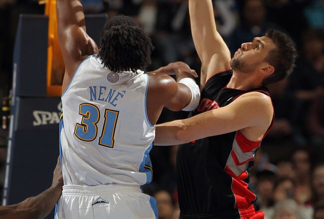DENVER, CO - MARCH 21:  Nene #31 of the Denver Nuggets takes a shot against the defense of Andrea Bargnani #7 of the Toronto Raptors at the Pepsi Center on March 21, 2011 in Denver, Colorado. NOTE TO USER: User expressly acknowledges and agrees that, by downloading and or using this photograph, User is consenting to the terms and conditions of the Getty Images License Agreement.  (Photo by Doug Pensinger/Getty Images)