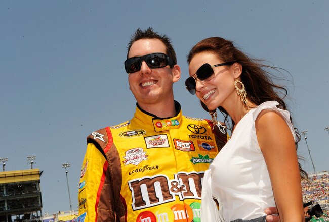 KANSAS CITY, KS - JUNE 05:  Kyle Busch, driver of the #18 M&M'sToyota, and his wife Samantha Sarcinella take part in pre-race ceremonies for the NASCAR Sprint Cup Series STP 400 at Kansas Speedway on June 5, 2011 in Kansas City, Kansas.  (Photo by John Harrelson/Getty Images for NASCAR)