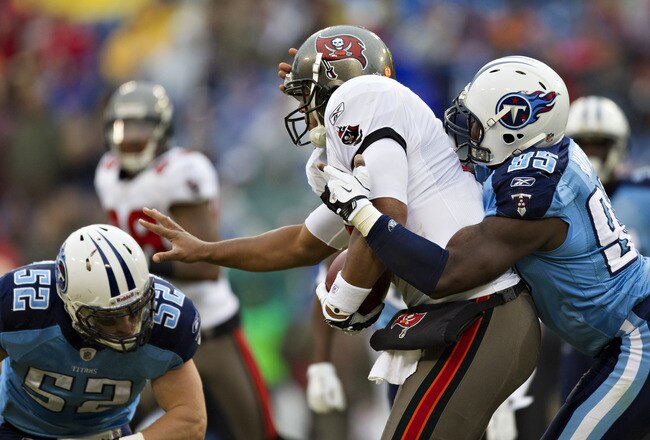 NASHVILLE, TN - NOVEMBER 27:   William Hayes #95 of the Tennessee Titans tackles Josh Freeman #5 of the Tampa Bay Buccaneers at LP Field on November 27, 2011 in Nashville, Tennessee.  The Titans defeated the Buccaneers 23 to 17.  (Photo by Wesley Hitt/Getty Images)