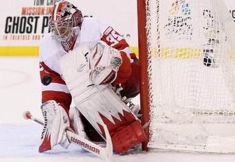 BOSTON, MA - NOVEMBER 25: Jimmy Howard #35 of the Detroit Red Wings stops a shot in the overtime period against the Boston Bruins on November 25, 2011 at TD Garden in Boston, Massachusetts. The Detroit Red Wings defeated the Boston Bruins 3-2 in an overtime shootout.  (Photo by Elsa/Getty Images)