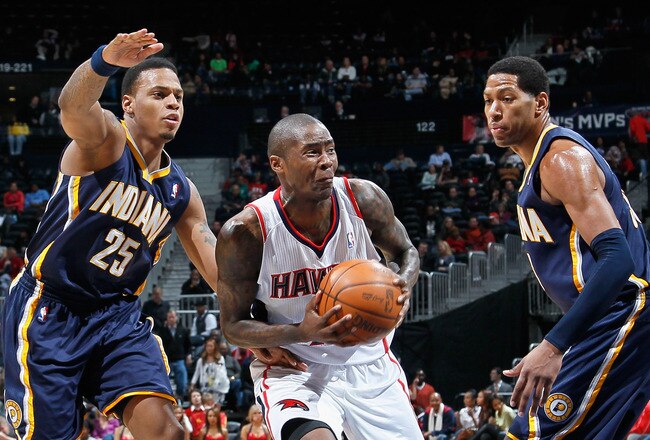 ATLANTA, GA - DECEMBER 11:  Jamal Crawford #25 of the Atlanta Hawks against Danny Granger #33 and Brandon Rush #25 of the Indiana Pacers at Philips Arena on December 11, 2010 in Atlanta, Georgia.  NOTE TO USER: User expressly acknowledges and agrees that, by downloading and/or using this Photograph, user is consenting to the terms and conditions of the Getty Images License Agreement.  (Photo by Kevin C. Cox/Getty Images)
