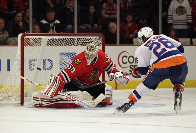 CHICAGO, IL - DECEMBER 02: Corey Crawford #50 of the Chicago Blackhawks defelects a shot by Matt Moulson #26 of the New York Islanders during a shootout at the United Center on December 2, 2011 in Chicago, Illinois. The Blkackhawks defeated the Islanders 5-4 in a shootout. (Photo by Jonathan Daniel/Getty Images)