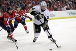 WASHINGTON, DC - DECEMBER 01: Matt Cooke #24 of the Pittsburgh Penguins moves the puck in front of Marcus Johansson #90 of the Washington Capitals during the first period at Verizon Center on December 1, 2011 in Washington, DC.  (Photo by Rob Carr/Getty Images)