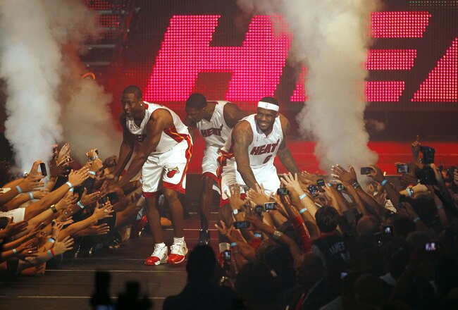 MIAMI - JULY 09:  Fans cheer as (L-R) Dwyane Wade #3, Chris Bosh #1 and LeBron James #6 of the Miami Heat are introduced during a welcome party at American Airlines Arena on July 9, 2010 in Miami, Florida.  (Photo by Marc Serota/Getty Images)