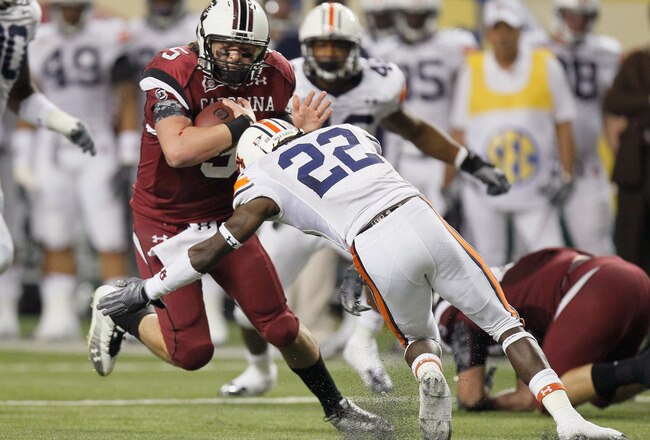 ATLANTA, GA - DECEMBER 04:  Stephen Garcia #5 of the South Carolina Gamecocks is tackled by T'Sharvan Bell #22 of the Auburn Tigers during the 2010 SEC Championship at Georgia Dome on December 4, 2010 in Atlanta, Georgia.  (Photo by Kevin C. Cox/Getty Images)
