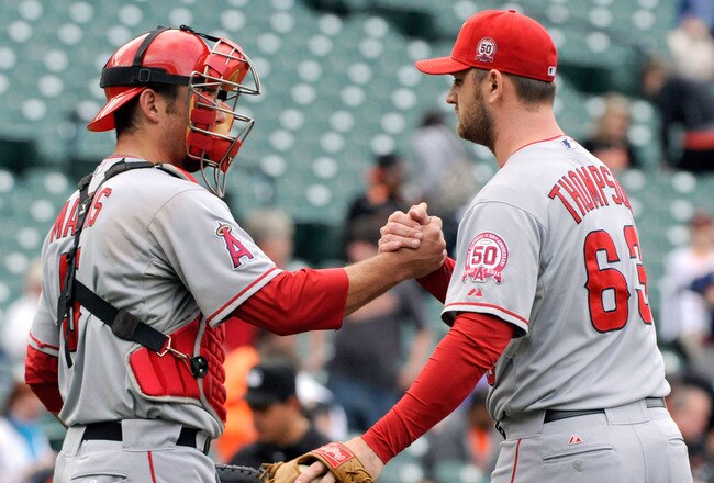BALTIMORE, MD - SEPTEMBER 18:  Catcher Jeff Mathis, left, #5 and pitcher Rich Thompson #63 of the Los Angeles Angels of Anaheim shake hands at the end of a baseball game against the Baltimore Orioles at Oriole Park at Camden Yards on September 18, 2011 in Baltimore, Maryland. The Angels beat the Orioles 11-2. (Photo by Steve Ruark/Getty Images)