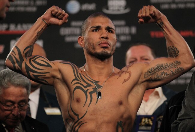 NEW YORK, NY - DECEMBER 02:  Miguel Cotto of Puerto Rico flexes his arms for the crowd on the scales ahead of his bout with Antonio Margarito of Mexico during their weigh in at The Theater at Madison Square Garden on December 2, 2011 in New York City.  (Photo by Nick Laham/Getty Images)
