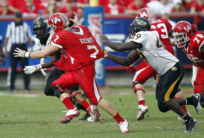 HOUSTON - DECEMBER 03:  Quarterback Case Keenum #7 of the Houston Cougars is sacked by Cordarro Law #49 of the Southern Miss Golden Eagles in the fourth quarter at Robertson Stadium on December 3, 2011 in Houston, Texas.  (Photo by Bob Levey/Getty Images)