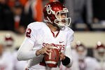 STILLWATER, OK - DECEMBER 03:  Landry Jones #12 of the Oklahoma Sooners throws against the Oklahoma State Cowboys at Boone Pickens Stadium on December 3, 2011 in Stillwater, Oklahoma.  (Photo by Ronald Martinez/Getty Images)