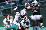 OAKLAND, CA - NOVEMBER 28:  Jacoby Ford #12 of the Oakland Raiders catches the ball while defended by Chris Clemons #30 of the Miami Dolphins at Oakland-Alameda County Coliseum on November 28, 2010 in Oakland, California.  (Photo by Ezra Shaw/Getty Images)