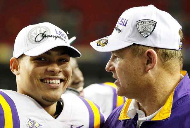 ATLANTA, GA - DECEMBER 03:  Head coach Les Miles of the LSU Tigers congratulates Tyrann Mathieu #7 after Mathieu earned the MVP trophy in their 42-10 win over the Georgia Bulldogs during the 2011 SEC Championship Game at Georgia Dome on December 3, 2011 in Atlanta, Georgia.  (Photo by Kevin C. Cox/Getty Images)