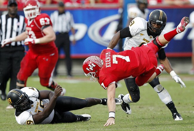 HOUSTON - DECEMBER 03:  Quarterback Case Keenum #7 of the Houston Cougars is sacked by Cordarro Law #49 of the Southern Mississippi Golden Eagles in the fourth quarter at Robertson Stadium on December 3, 2011 in Houston, Texas.  (Photo by Bob Levey/Getty Images)