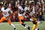 AMES, IA - NOVEMBER 18:  Justin Blackmon #81 of the Oklahoma State Cowboys stiff arms C. J. Morgan # 27 of the Iowa State Cyclones at Jack Trice Stadium November 18, 2011 in Ames, Iowa.  (Photo by Reese Strickland/Getty Images)