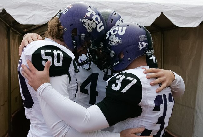 BOISE, ID - NOVEMBER 12:  Daniel Shelley #50, Anson Kelton #4, and Ross Evans #37 of the TCU Horned Frogs psyche up before the game against the Boise State Broncos at Bronco Stadium on November 12, 2011 in Boise, Idaho.  (Photo by Otto Kitsinger III/Getty Images)
