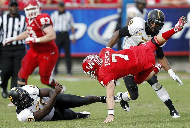 HOUSTON - DECEMBER 03:  Quarterback Case Keenum #7 of the Houston Cougars is sacked by Cordarro Law #49 of the Southern Mississippi Golden Eagles in the fourth quarter at Robertson Stadium on December 3, 2011 in Houston, Texas.  (Photo by Bob Levey/Getty Images)