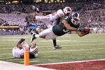 INDIANAPOLIS, IN - DECEMBER 03:  B.J. Cunningham #3 of the Michigan State Spartans runs the ball 6-yards into the endzone after he got the ballo n a lateral by Keith Nichol #7 against Antonio Fenelus #26 and Kevin Claxton #9 of the Wisconsin Badgers during the second quarter of the Big 10 Conference Championship Game at Lucas Oil Stadium on December 3, 2011 in Indianapolis, Indiana.  (Photo by Andy Lyons/Getty Images)