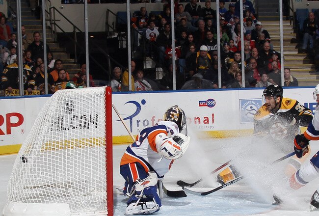 UNIONDALE, NY - NOVEMBER 19: Patrice Bergeron #37 of the Boston Bruins scores past Rick DiPietro #39 of the New York Islanders at 7:08 of the first period at the Nassau Veterans Memorial Coliseum on November 19, 2011 in Uniondale, New York.  (Photo by Bruce Bennett/Getty Images)