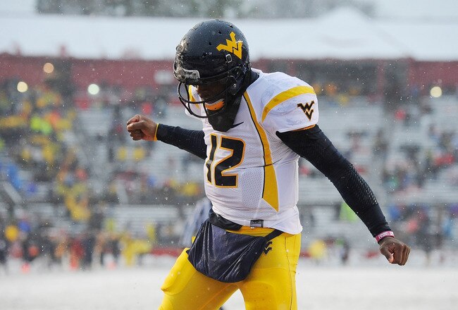 NEW BRUNSWICK, NJ - OCTOBER 29:  Geno Smith #12 of the West Virginia Mountaineers celebrates after Shawne Alston #20 of the Mountaineers scored a touchdown against the Rutgers Scarlet Knights at High Point Solutions Stadium on October 29, 2011 in New Brunswick, New Jersey.  (Photo by Patrick McDermott/Getty Images)