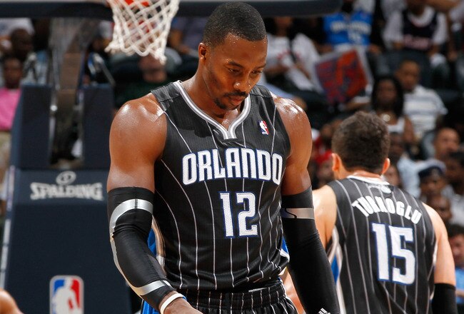 ATLANTA, GA - APRIL 24:  Dwight Howard #12 of the Orlando Magic walks downcourt after a turnover to the Atlanta Hawks during Game Four of the Eastern Conference Quarterfinals in the 2011 NBA Playoffs at Philips Arena on April 24, 2011 in Atlanta, Georgia.  NOTE TO USER: User expressly acknowledges and agrees that, by downloading and or using this photograph, User is consenting to the terms and conditions of the Getty Images License Agreement.  (Photo by Kevin C. Cox/Getty Images)