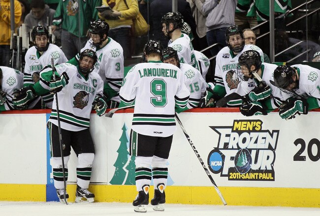 ST. PAUL, MN - APRIL 07:  The North Dakota Fighting Sioux watch as the Michigan Wolverines celebrate the win after the semifinals of the 2011 NCAA Men's Frozen Four on April 7, 2011 at the Xcel Energy Center in St. Paul, Minnesota. The Michigan Wolverines defeated the North Dakota Fighting Sioux 2-0.  (Photo by Elsa/Getty Images)