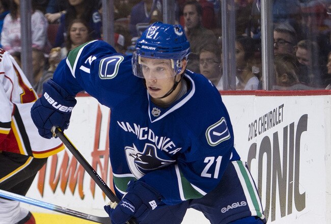 VANCOUVER, CANADA - DECEMBER 4: Mason Raymond #21 of the Vancouver Canucks skates with the puck during NHL action on December 04, 2011 against the Calgary Flames at Rogers Arena in Vancouver, British Columbia, Canada.  (Photo by Rich Lam/Getty Images)