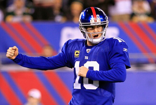 EAST RUTHERFORD, NJ - DECEMBER 04:  Eli Manning #10 of the New York Giants celebrates after Brandon Jacobs #27 scored a 1-yard rushing touchdown in the second quarter against the Green Bay Packers at MetLife Stadium on December 4, 2011 in East Rutherford, New Jersey.  (Photo by Chris Trotman/Getty Images)