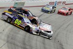 BRISTOL, TN - MARCH 20:  David Reutimann, driver of the #00 Aaron's Dream Machine Toyota, Brian Vickers, driver of the #83 Red Bull Toyota, and Denny Hamlin, driver of the #11 FedEx Express Toyota, collide after an incident in the NASCAR Sprint Cup Series Jeff Byrd 500 Presented By Food City at Bristol Motor Speedway on March 20, 2011 in Bristol, Tennessee.  (Photo by Chris Trotman/Getty Images)
