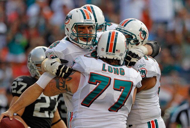 MIAMI GARDENS, FL - DECEMBER 04:  Matt Moore #8 of the Miami Dolphins celebrates a touchdown during a game against the Oakland Raiders at Sun Life Stadium on December 4, 2011 in Miami Gardens, Florida.  (Photo by Mike Ehrmann/Getty Images)